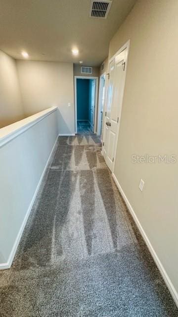 hallway with carpet floors