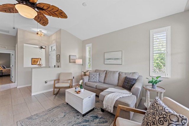 living room with ceiling fan and vaulted ceiling