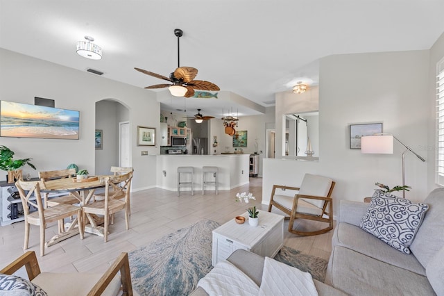 living room featuring ceiling fan and light tile patterned floors