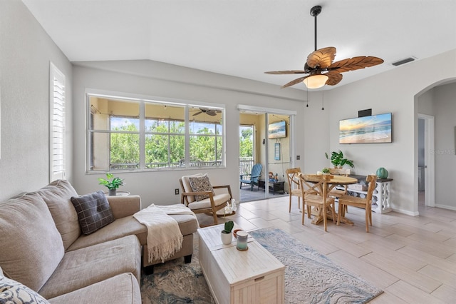 tiled living room with lofted ceiling and ceiling fan