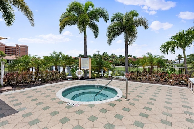 view of pool with a hot tub and a patio