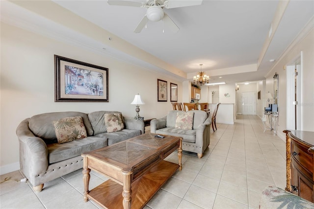 living room featuring light tile patterned floors, a raised ceiling, and ceiling fan with notable chandelier