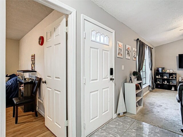 foyer with a textured ceiling