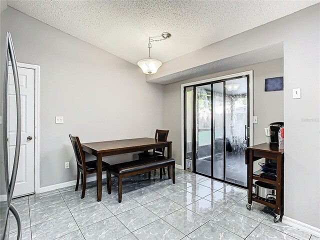 dining area featuring a textured ceiling