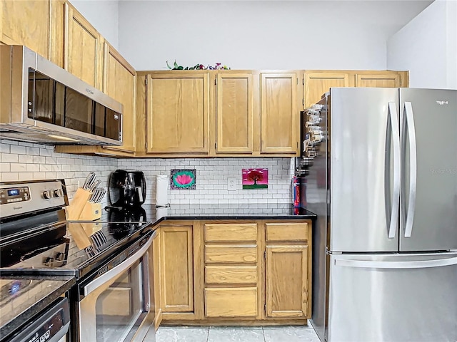 kitchen with stainless steel appliances, light tile patterned floors, and backsplash