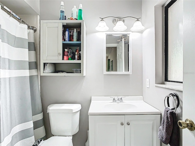 bathroom with vanity, toilet, and a shower with shower curtain