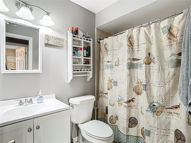 bathroom with vanity, toilet, and walk in shower