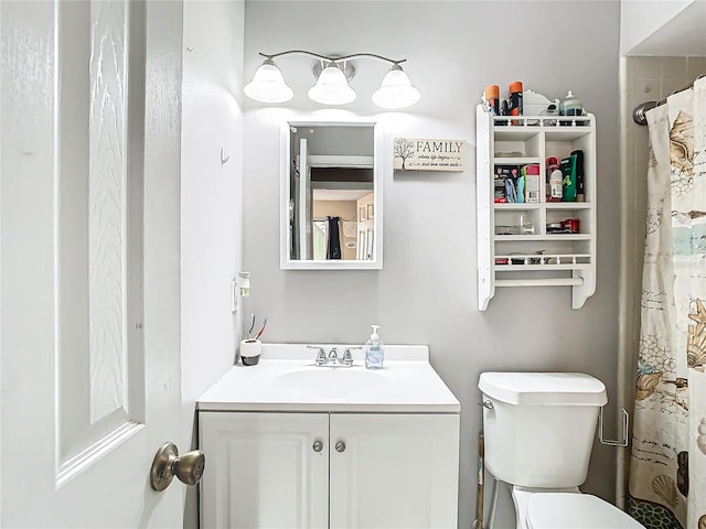 bathroom with vanity, toilet, and curtained shower