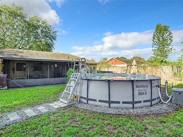 view of yard featuring a fenced in pool and a sunroom