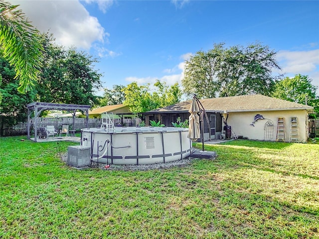 view of yard with a fenced in pool and a pergola