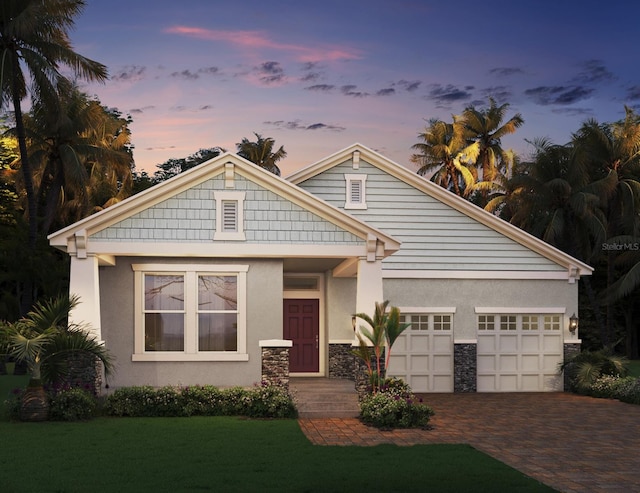 view of front of property featuring a lawn and a garage