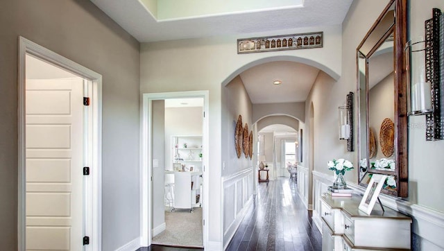 corridor with dark hardwood / wood-style flooring