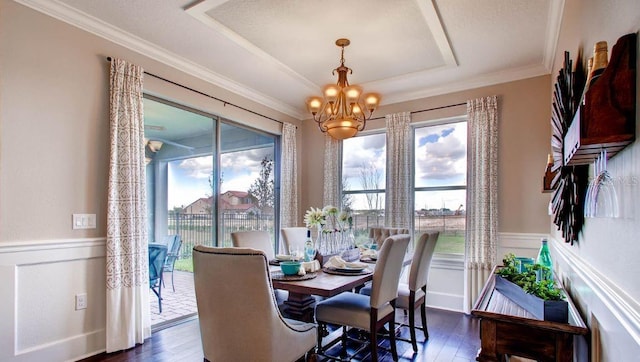 dining room with plenty of natural light, dark hardwood / wood-style floors, and a chandelier