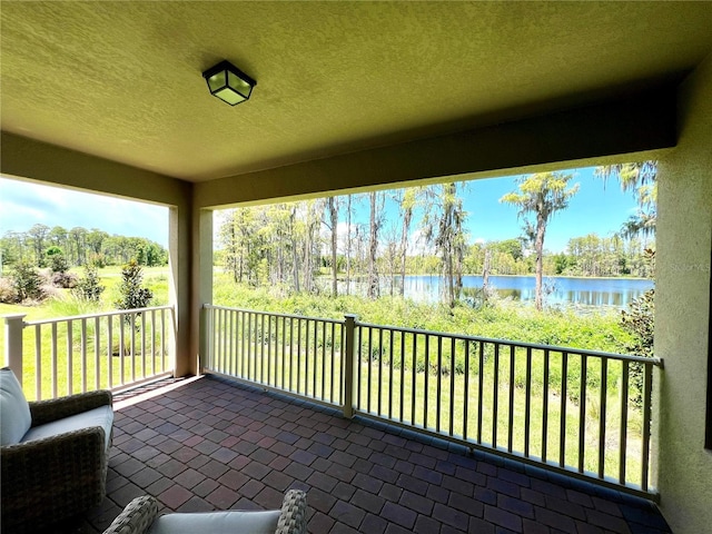 unfurnished sunroom featuring a water view