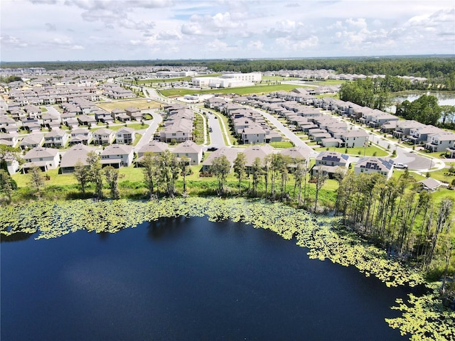 drone / aerial view featuring a residential view and a water view