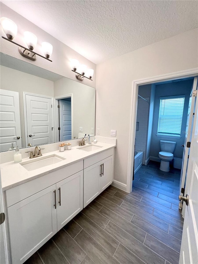 full bath with wood finish floors, a sink, and toilet