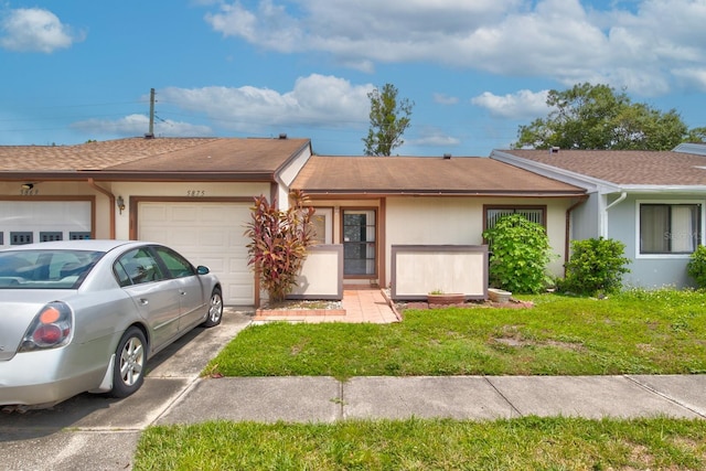 single story home featuring a garage and a front yard