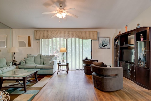 living room featuring hardwood / wood-style floors and ceiling fan