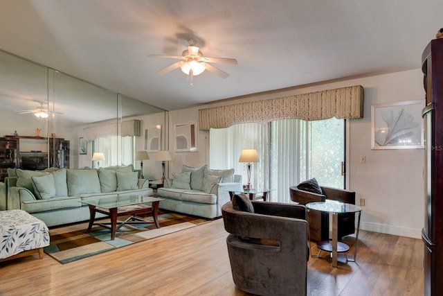 living room with hardwood / wood-style flooring, ceiling fan, and a wealth of natural light