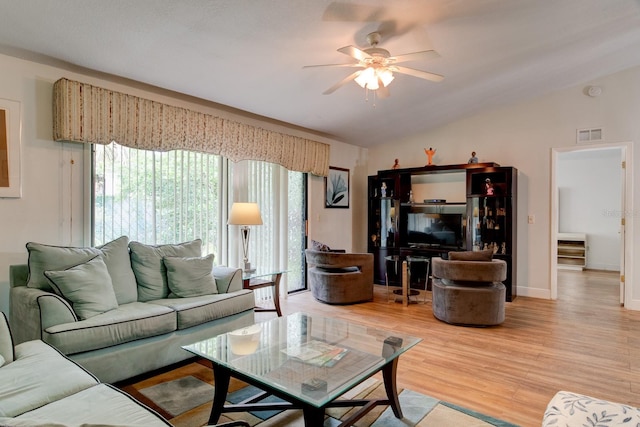 living room featuring lofted ceiling, wood-type flooring, and ceiling fan