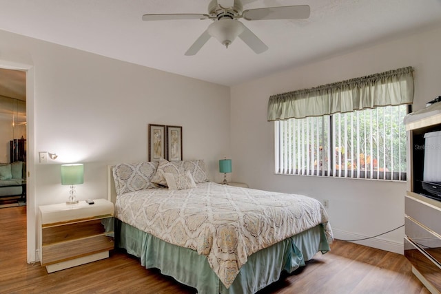 bedroom with wood-type flooring and ceiling fan