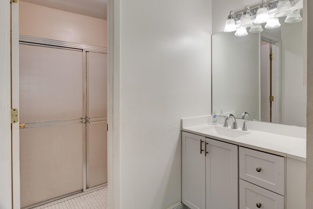 bathroom with walk in shower, tile patterned floors, and vanity