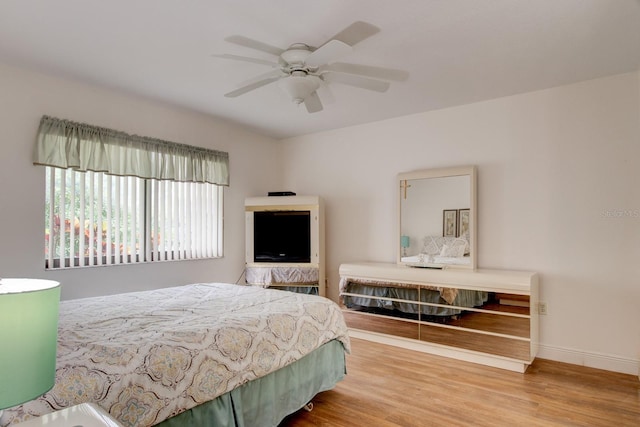 bedroom with hardwood / wood-style flooring and ceiling fan