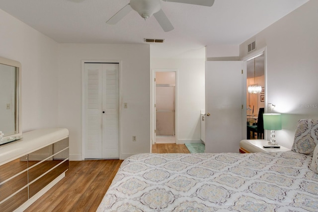 bedroom featuring hardwood / wood-style floors, ceiling fan, and a closet