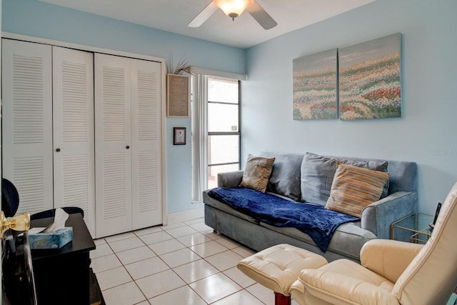 living room with ceiling fan and light tile patterned floors