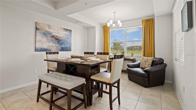 dining room with light tile patterned floors and an inviting chandelier