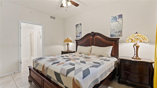 bedroom with ensuite bath, light tile patterned floors, and ceiling fan