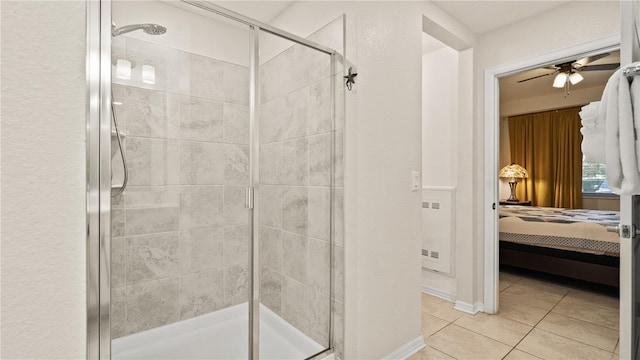 bathroom with walk in shower, ceiling fan, and tile patterned flooring