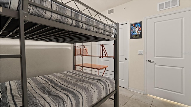 bedroom with light tile patterned floors