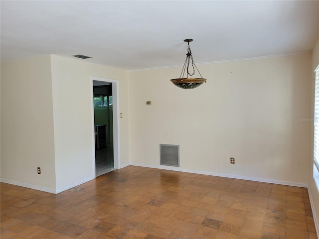 empty room featuring hardwood / wood-style floors and ornamental molding