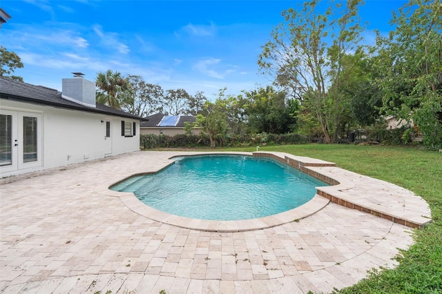 view of pool with a lawn and a patio area