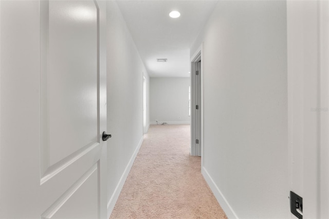 hallway with light colored carpet