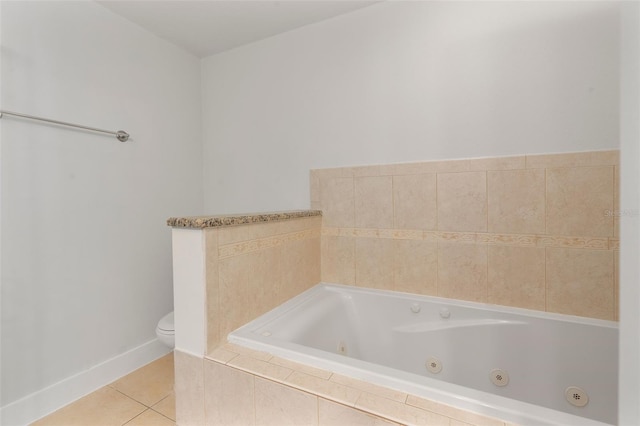 bathroom featuring tiled bath, tile patterned flooring, and toilet