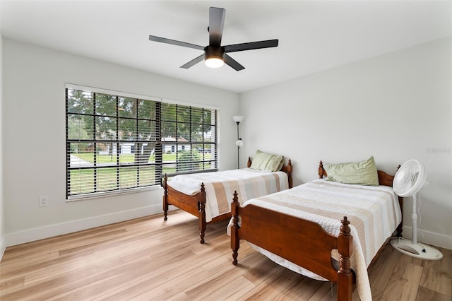 bedroom with light hardwood / wood-style flooring and ceiling fan