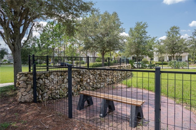 view of gate featuring a yard