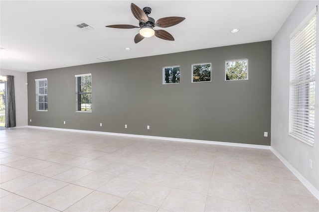 unfurnished room with light tile patterned flooring, ceiling fan, and a healthy amount of sunlight