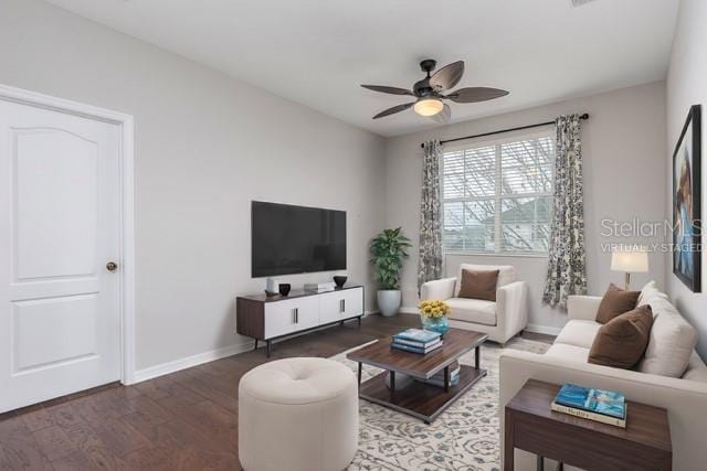 living room with dark hardwood / wood-style flooring and ceiling fan