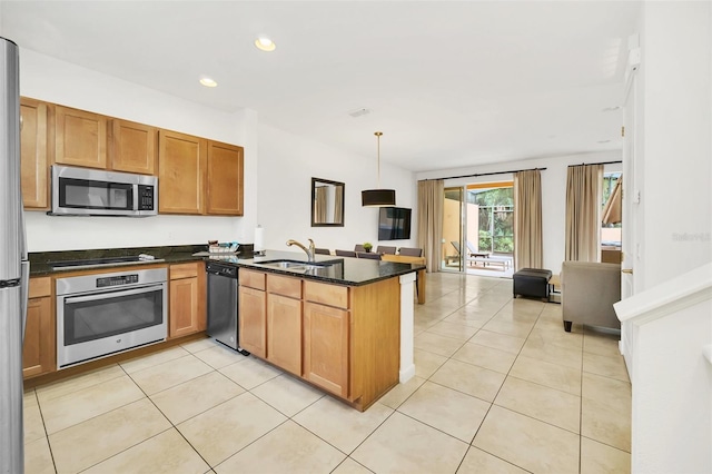 kitchen with pendant lighting, stainless steel appliances, kitchen peninsula, sink, and light tile patterned flooring