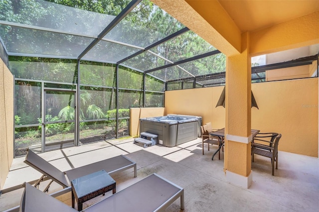 view of patio with a lanai and a hot tub