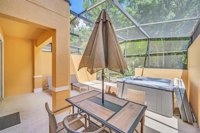 view of patio / terrace with glass enclosure and a hot tub