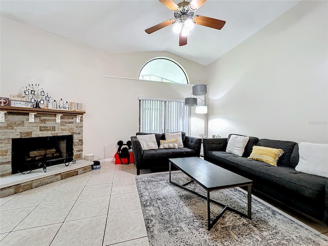 living room featuring lofted ceiling, ceiling fan, light tile patterned floors, and a fireplace