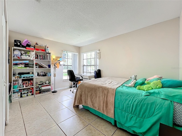 tiled bedroom featuring a textured ceiling