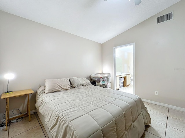 bedroom featuring vaulted ceiling, light tile patterned floors, and ceiling fan