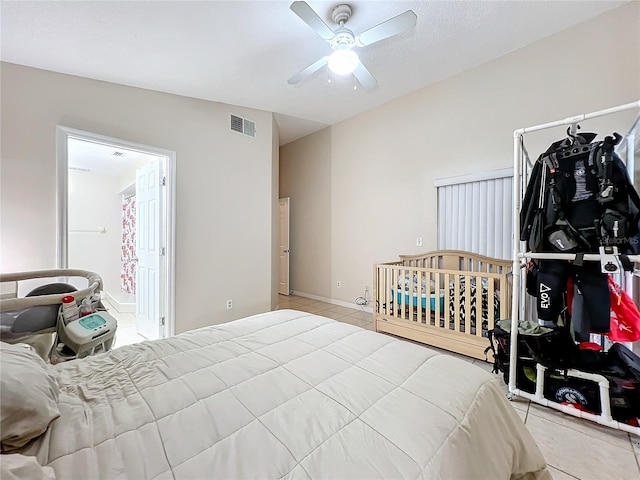 tiled bedroom featuring vaulted ceiling, a textured ceiling, and ceiling fan