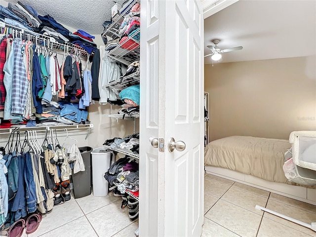 spacious closet featuring ceiling fan and light tile patterned floors