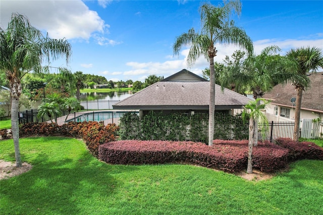 view of yard featuring a fenced in pool and a water view